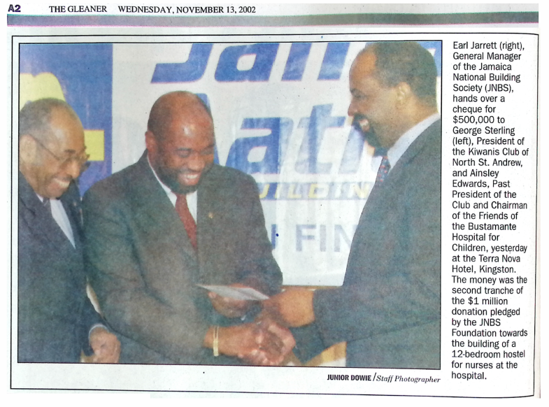 Earl Jarrett hands over a cheque, The Gleaner