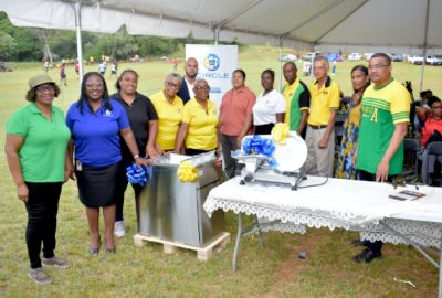 The JN Foundation presented the Cross Keys Development Area Committee with a deep fryer and commercial slicer for its agro-processing facility and a pavilion stand in Cross Keys, Manchester. On hand to make the presentation were Alethia Peart (second left), business relationship and sales manager (BRASM) at JN Bank and Dawnette Pryce-Thompson (fifth right), project coordinator, JN Foundation. Sharing in the moment are (from left): Councillor Iceval Brown of the Grove Town Division; Wendy Freckleton, president of the JN Circle, Mandeville; Doreen Spence and Rev. Joan Smith, JN Circle members; Karon Lewis, acting BRASM JN Bank, Mandeville; Karen Wong; Smeadly Reid, chairman Cross Keys Development area; Anthony Freckleton, chairman of the Manchester Parish Development Committee; Collen Wint-Bond, daughter of Arthur Wint and Robert chin, Member of Parliament of Manchester Southern. The presentation was made at the opening ceremony of the Arthur Wint Day and Jamaica 60th Independence Fair in the community, recently.