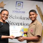 Claudine Allen, general manager of the JN Foundation presents the 2023 PEP awardee from St Andrew, Mason Smith, with a certificate during the JN Foundation’s PEP Scholarship Awards held at the Summit in New Kingston on November 12, 2023