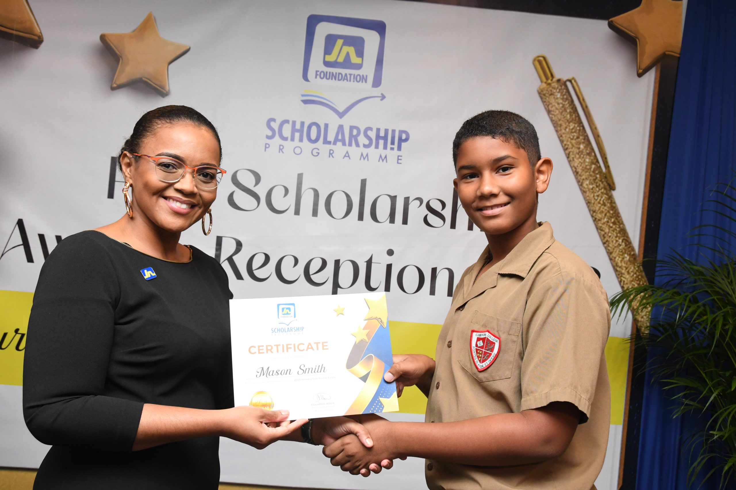 Claudine Allen, general manager of the JN Foundation presents the 2023 PEP awardee from St Andrew, Mason Smith, with a certificate during the JN Foundation’s PEP Scholarship Awards held at the Summit in New Kingston on November 12, 2023